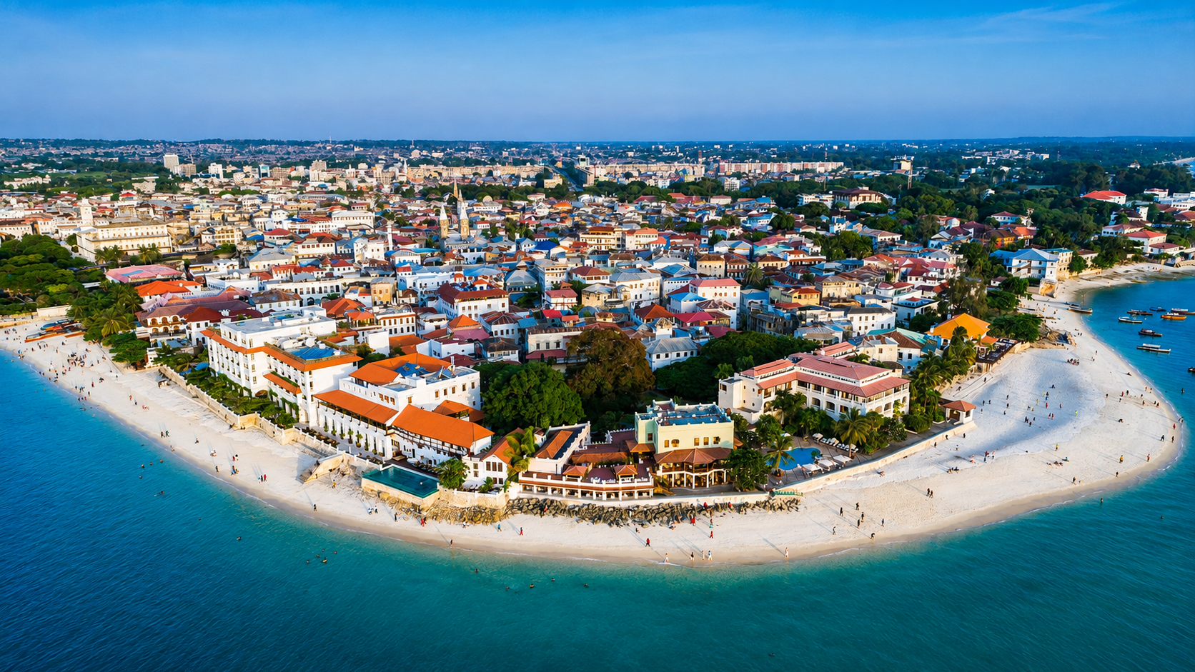 Aerial view of Stone Town, Zanzibar, surrounded by turquoise water and white beaches